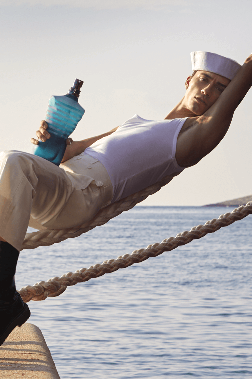 Visual of the new campaign with the sailor on a rope with the fragrance Le Male